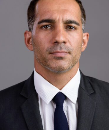 Studio shot of mature handsome Persian businessman in suit isolated against white background