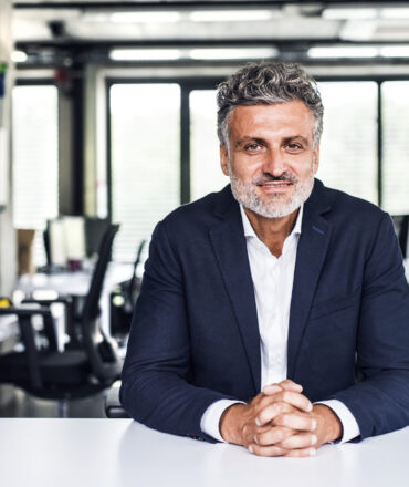 Portrait of smiling mature businessman in office